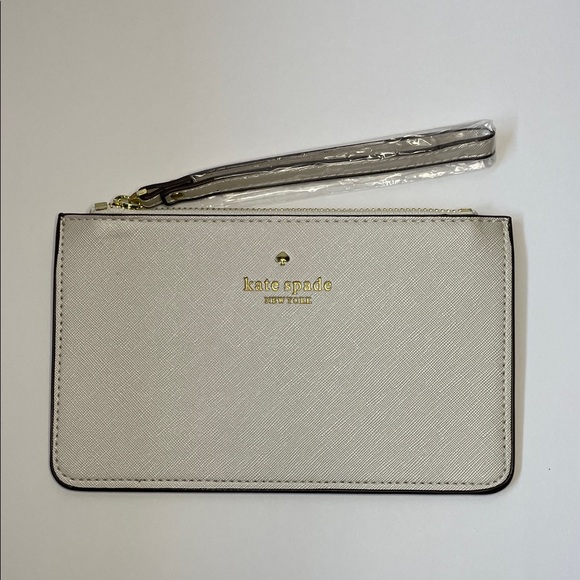 kate spade Handbags - NWT Kate Spade cream saffiano wristlet with gold logo.  8x5”